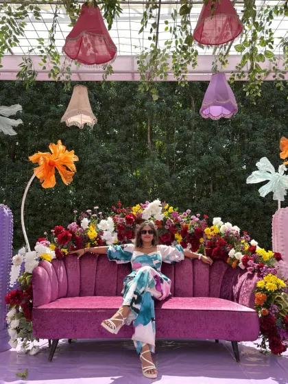 Spreading my arms wide to embrace the grand and colorful decor of the wedding carnival.
