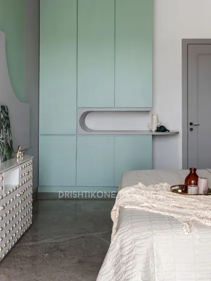 A look at the custom wardrobe in our nature-inspired bedroom. The soft mint green color and curved niche provide both stylish storage and a unique design element that complements the room's gentle aesthetic.