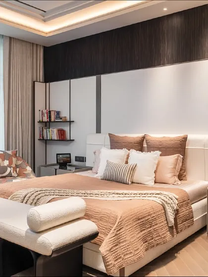 This bedroom features a unique custom sofa with a camouflage-print fabric, adding an unexpected and personal touch to the space. The rest of the room is kept neutral to balance the bold pattern.
