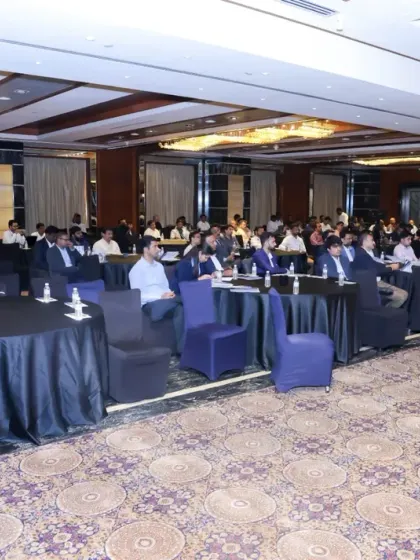 This wide shot captures the audience and room layout during a session at the CII conference. It provides a complete overview of the event environment, from the attendees to the venue's decor.