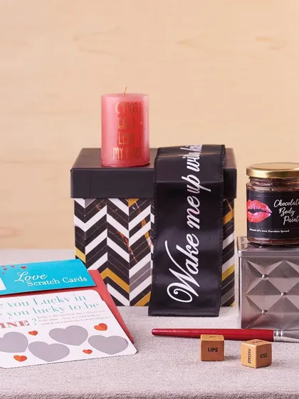 A closer look at the playful elements in this romantic hamper, including love-themed games and a jar of edible chocolate body paint.