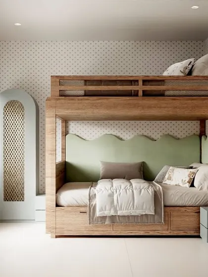 An Indian-inspired theme for a kids' room. This space features a beautiful wooden bunk bed with a scalloped green headboard, a matching arched wardrobe, and subtle traditional patterns on the wallpaper.