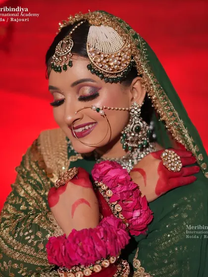 A smiling bride, with a close-up on her 'passa' and 'maang tikka', showcasing the precision of the hairstyling.