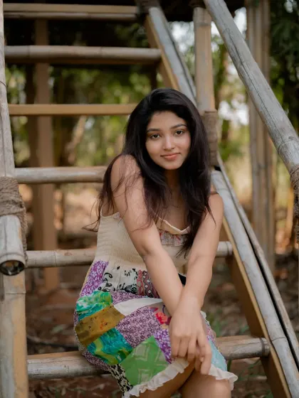 A duplicate of image 305, this candid and happy portrait of actress Rachana Inder on a bamboo ladder is full of joy and natural beauty.
