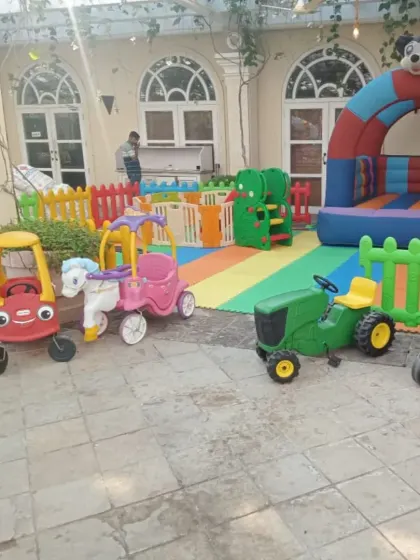 This party setup on a beautiful tiled patio shows how versatile my playzones are. I brought in a fleet of ride-on cars, including a police car and a tractor, along with a Mickey Mouse themed bouncy arch, creating a perfect race-track feel for the kids.