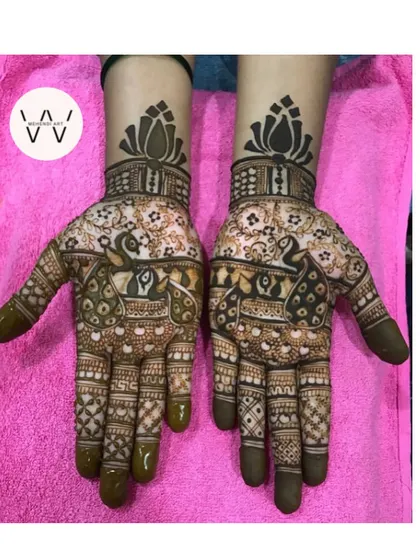 A stunning design for a bridesmaid with two large peacocks and lotus cuffs.