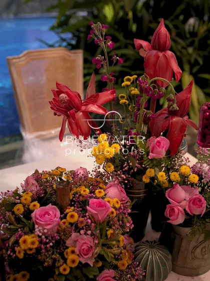 A close-up of a rich, colorful floral arrangement with deep red and yellow blooms.