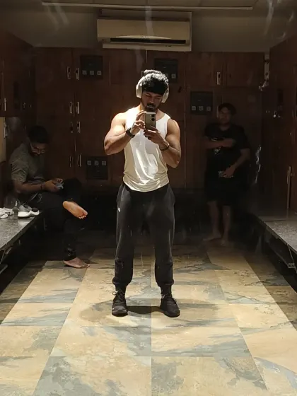A full-body shot in the locker room. This is my space to reflect on the work I've put in.