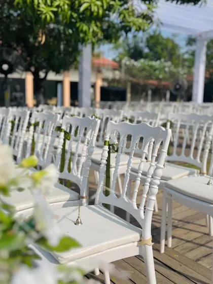 A detail of the guest seating, with small bells attached to the chairs. This is a sweet, interactive element, allowing guests to ring in celebration of the couple's union.