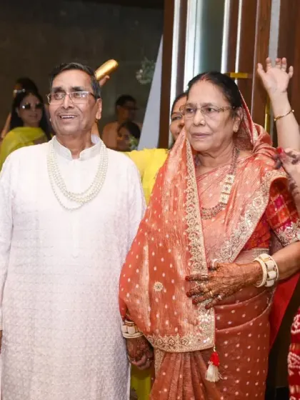 The couple's grand entrance, accompanied by dhol players and dancing family members.