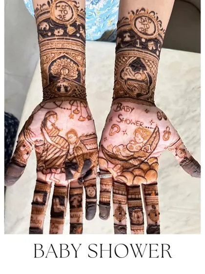 A beautiful baby shower design with a mother and baby, and another baby sleeping in a cradle. So much love in this henna.