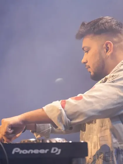A close-up, focused shot from a live set. The concentration is intense.