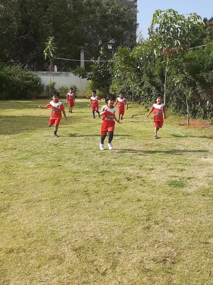 A group of toddlers running on the field, full of energy. We keep them moving and smiling!