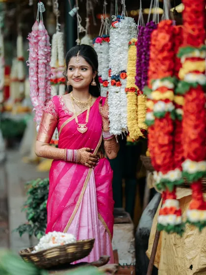 A beautiful pre-wedding portrait of the bride-to-be at a vibrant flower market in Bangalore, a perfect setting for a traditional yet candid photoshoot.