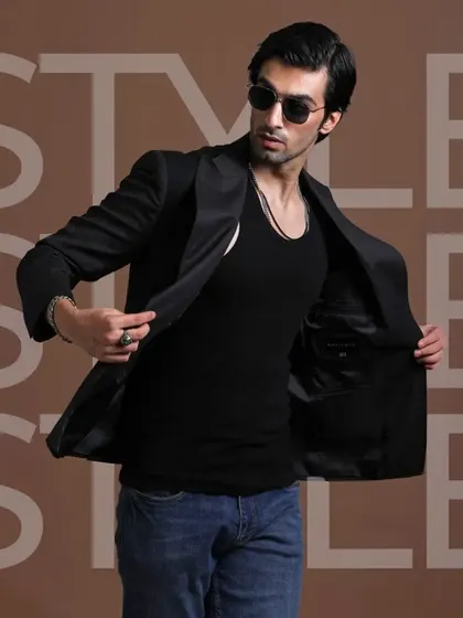 A black blazer paired with a tank top and jeans. This look is all about confidence and style, proving that a well-tailored jacket can elevate any outfit.