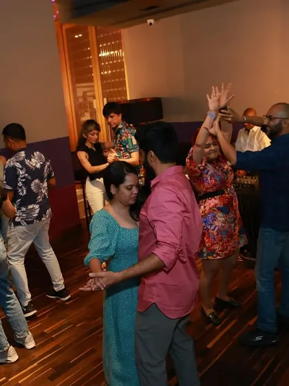 A snapshot of the social dancing scene at Wink. Multiple couples are on the floor, lost in the rhythm of Salsa and Bachata. This is where friendships are made and skills are sharpened.