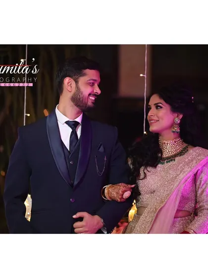 A classic reception look. The way they look at each other speaks volumes, a perfect candid moment captured as they walk together.