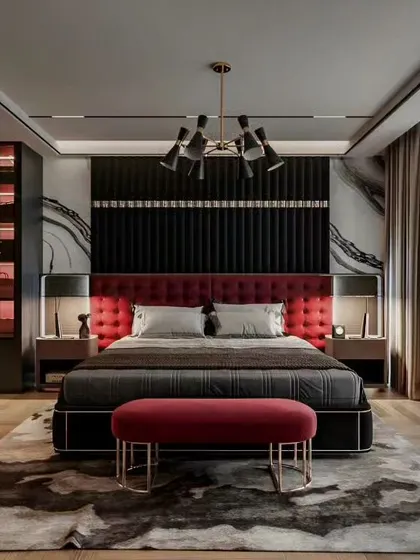A front view of the luxurious black and red master bedroom, highlighting the symmetry and striking contrast. The elegant chandelier and paneled accent wall create a powerful focal point in this high-end design.