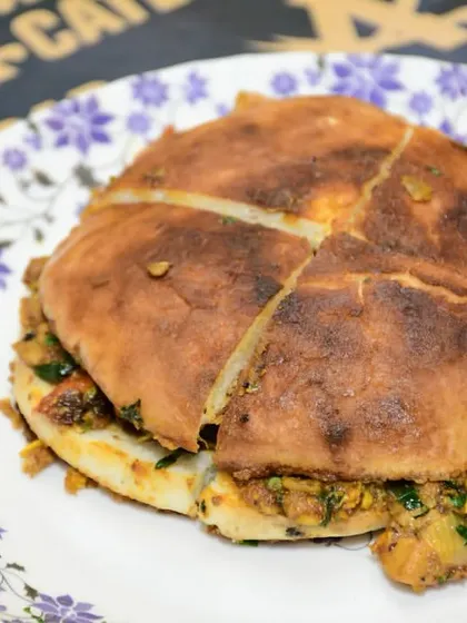 Our Baida Roti, stuffed with a savory filling and cooked on the tava until golden brown. It's a complete meal in itself.