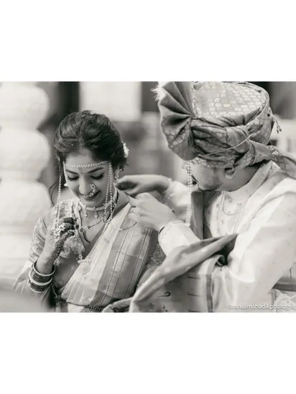 A timeless black and white photo capturing a quiet, intimate moment between the bride and groom.