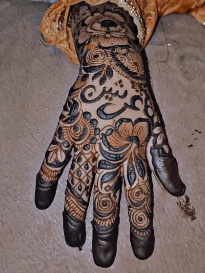 I love personalizing mehendi designs. This intricate floral pattern includes the child's name written beautifully in Arabic script, making it a unique and special design just for her.