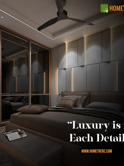 Luxury is in the details. This bedroom features a dark, moody aesthetic with a floor-to-ceiling upholstered wall, integrated vertical lighting, and a sleek wardrobe with smoked mirror doors.