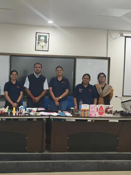 Our team stands proudly at the Department of Physical Education, Banaras Hindu University, after a 'Simply Periods' workshop. The table is filled with educational materials and various period products to facilitate a comprehensive learning experience.