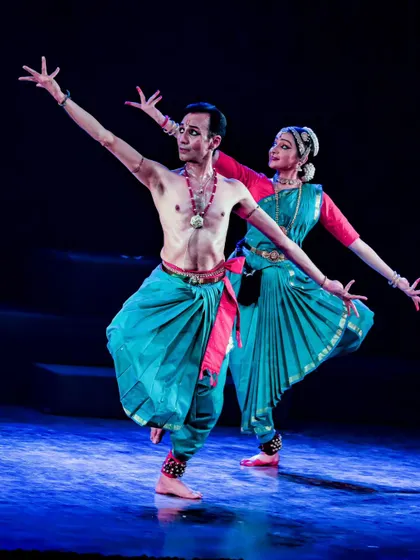 A duet from "Tyāgarāja Hṛt Sādana," showcasing the beautiful lines and symmetry of Bharatanatyam. The coordination between the two dancers is key to the performance's success.