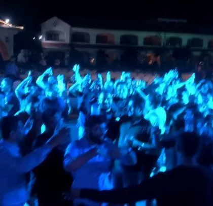 A corporate event for ABB, with the crowd dancing under blue lights.