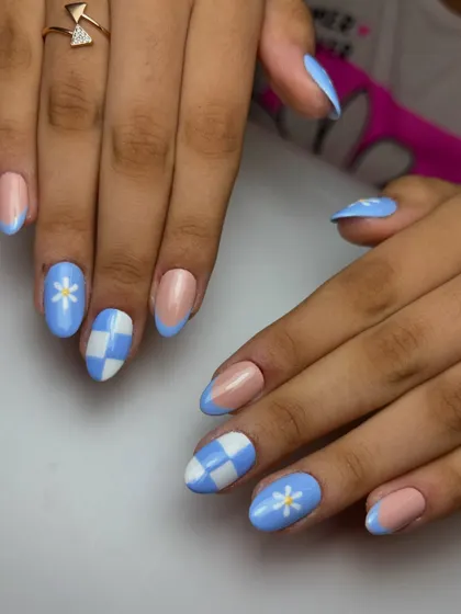 Celebrating a big win for team India. This client wanted to show her support with a blue-themed set, featuring checkerboards, daisies, and French tips in a victory blue.