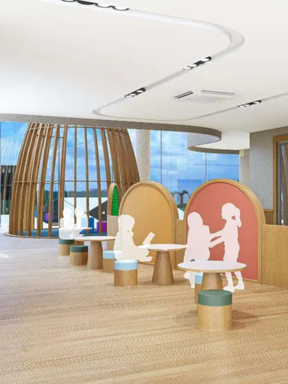 A render of a play and learning area at Mother's Pet School. The design uses child-sized furniture and playful partitions to create distinct zones for different activities while maintaining an open feel.