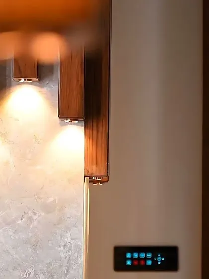 A smart panel's glow is visible next to a beautifully lit wooden feature wall, showing the seamless blend of tech and design.