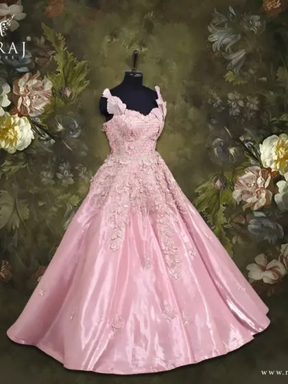Blooming in peach, this beautifully designed gown features delicate floral appliqué, perfect for the modern muse.