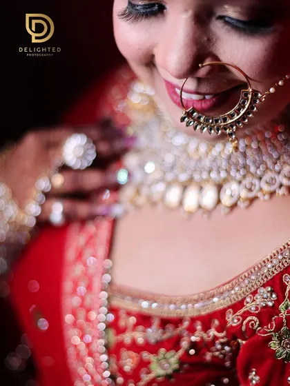 A detailed close-up of the bride, focusing on her smile and traditional jewelry. The shallow depth of field creates a soft, dreamy look.