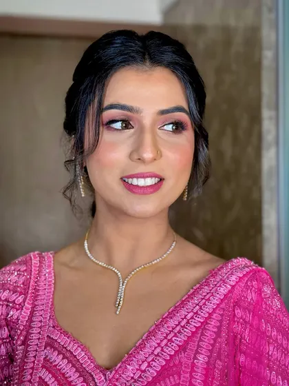 A soft and pretty look for a 'Mata Ki Chowki' ceremony, with a bright pink outfit and subtle makeup.