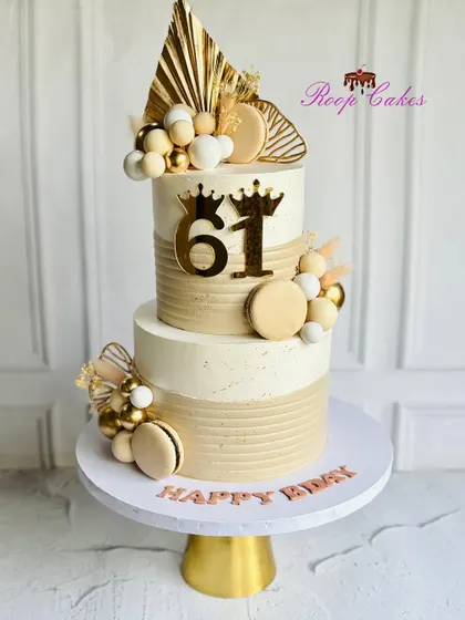 A cake as elegant as the journey it celebrates. This two-tier cake for a 61st birthday features sophisticated beige and gold tones.