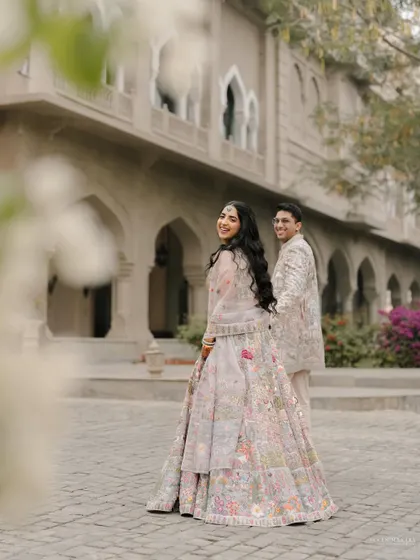 A playful glance back. This photo captures the fun and flirty side of Heena and Shlok's relationship amidst a beautiful palace setting.