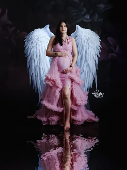 A fantasy-themed portrait featuring beautiful angel wings. We love bringing your creative ideas to life with unique props and concepts.