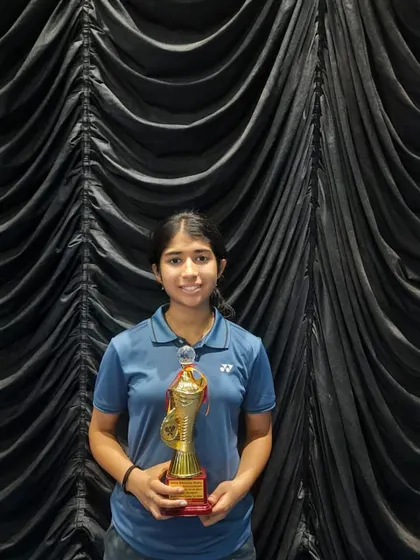 Nandini proudly holding her trophy after securing a silver medal at the school state championship.