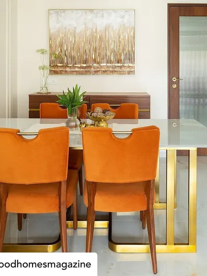 The dining room from our 'Calm Abode' project, featured in Good Homes Magazine. We used bold, burnt-orange velvet chairs to add a pop of color and warmth, contrasting beautifully with the white marble table and brass accents.