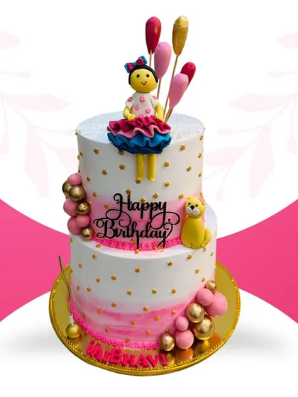 This is one of my grandest creations, a 10-pound, two-tier cake perfect for a big celebration. It features my special Rasmalai fusion flavor and is decorated with a beautiful doll topper, balloons, and personalized details for a truly memorable birthday.