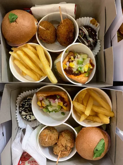 Two snack boxes side-by-side, showing the delicious assortment of treats inside.