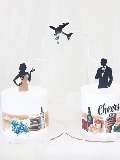 A unique concept for a couple who lives in different cities. Two separate cakes are connected by a flight path, each decorated with edible prints that represent their individual lives and personalities.