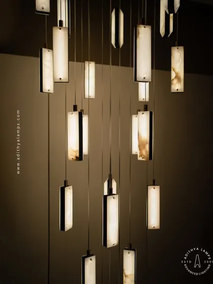 These modern pendants feature a unique combination of translucent marble and stitched leather accents. The warm light glows through the marble, creating a sophisticated and texturally rich fixture for contemporary spaces.
