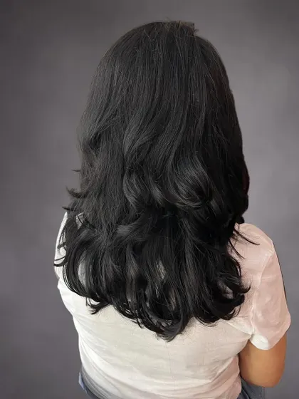 The back view of Jyoti's layered haircut.