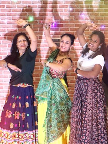 Three participants striking a pose during our Zumba Garba session. I love to fuse different styles to keep things fresh and exciting.