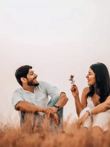 A duplicate of image 133, capturing a sweet and simple pre-wedding moment in a field.