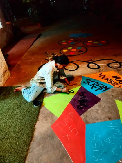 Painting through the night to get this interactive mural ready. The design includes instructions like "Jump x5" and "Scream," turning the floor into a game controller.