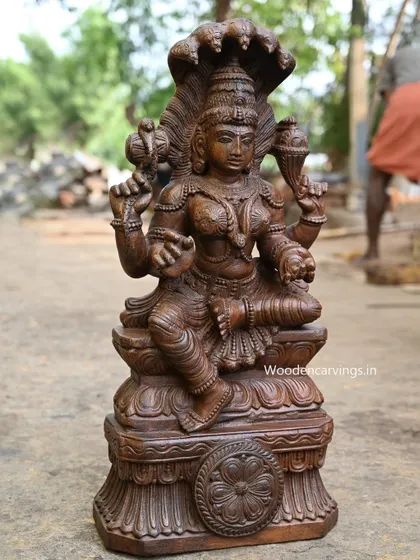 The Naga Rani statue from a distance, showing its complete form on its ornate base.