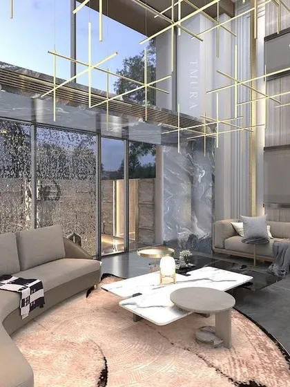 This angle shows how we use area rugs and furniture grouping to create a cozy conversation pit within a larger, open space. The custom gold lighting grid above connects the entire room visually.